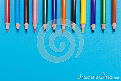 Back to scool - Pencils detail. Colored sharp pencils detail in a row, isolated on blue and yellow Stock Photo