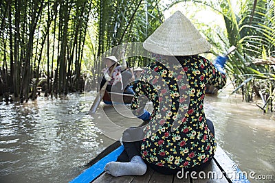 Back of vietnamese waman on the Mekong river, Vietnam Editorial Stock Photo