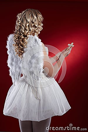 Back view of angel with crucifix Stock Photo