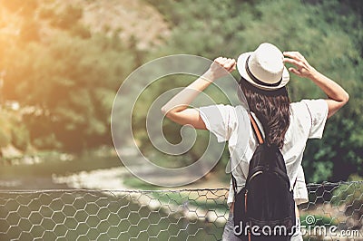 Rear view of brunette girl in park in straw hat. Stock Photo