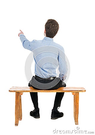 Back view of business man sitting on chair and pointing. Stock Photo