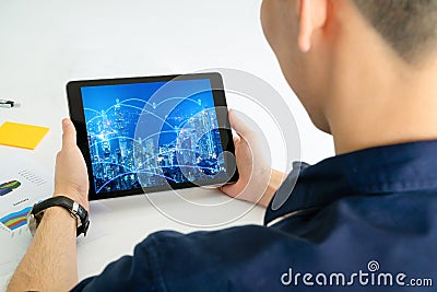 Back view of Business man using tablet for internet of thing network Stock Photo