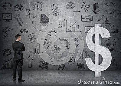 Back view of a businessman looking at big 3D concrete dollar sign. Stock Photo