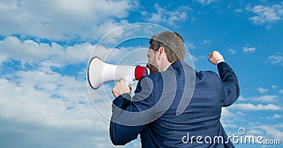 back view of businessman shout in loudhailer on sky background Stock Photo