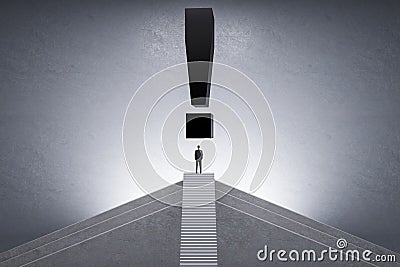 Back view of businessman on top of stairs with black exclamation mark on concrete background. Future, answer, idea and solution Stock Photo