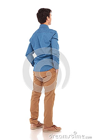 Back view of a casual man with hands in pockets Stock Photo