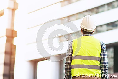 Back view of engineering man construction worker wear safety helmet and wear reflective clothing for the safety of the work operat Stock Photo