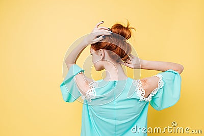 Back view of Enigmatic ginger woman in dress posing Stock Photo
