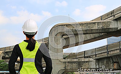 Back view of female construction worker against expressway background Stock Photo