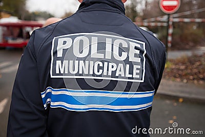 Back view of french policeman police municipal means local police in french Stock Photo