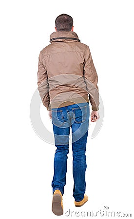 Back view of going handsome man in brown wind breaker Stock Photo
