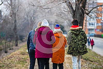 Back view, group of teenagers walking on the alleys of park in Targoviste, Romania, 2020 Editorial Stock Photo