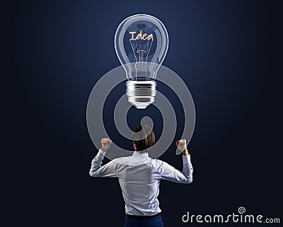 Back view of businessman with creative glass idea light bulb on dark background. Inspiration and genius concept Stock Photo