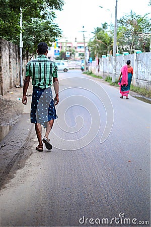 Back view Indian young man walking on street Editorial Stock Photo