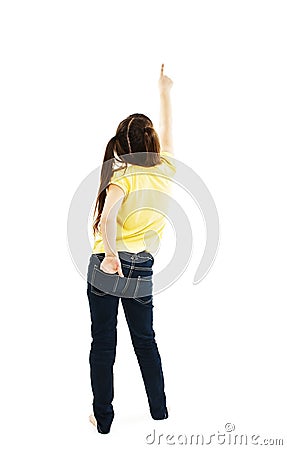 Back view of little girl points at wall. Rear view Stock Photo