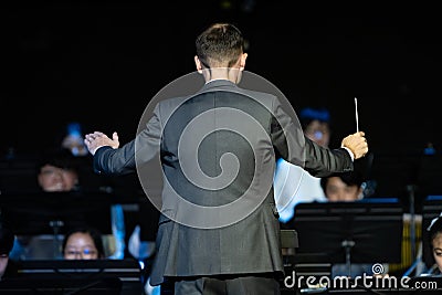 Male band conductor conducting his concert band Editorial Stock Photo