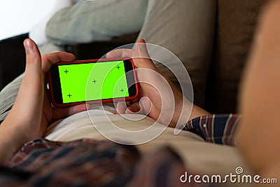 Back View of man of Green Mock-up Screen Smartphone. Chroma Key with Tracking Markers. close-up. Stock Photo