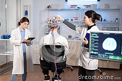 Back view of man patient wearing performant brainwave scanning headset Stock Photo