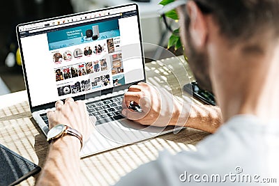 back view of man using laptop with amazon website Editorial Stock Photo