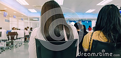 Back view of people sit and waiting in financial transactions Editorial Stock Photo