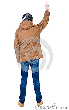 Back view of pointing young men in parka. Stock Photo