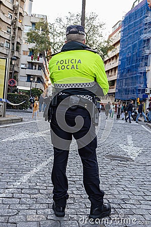 Back view of a police with the text in spanish Editorial Stock Photo