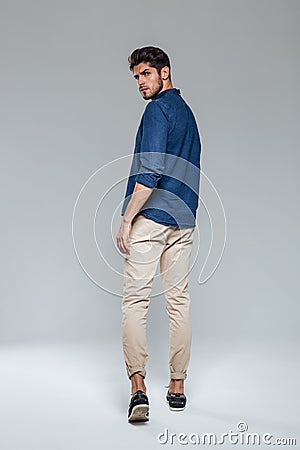 Back view portrait of a casual man walking Stock Photo