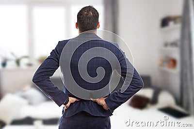 Back view of realtor suffering lumbar pain Stock Photo