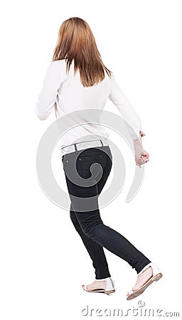 Back view of running woman in jeans Stock Photo