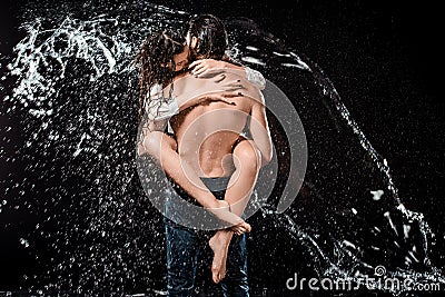 back view of sexy young couple swilled with water Stock Photo