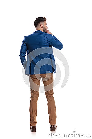 Back view of smart guy thinking with hand at chin Stock Photo