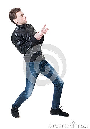 Back view of standing man pulling a rope from the top or cling t Stock Photo