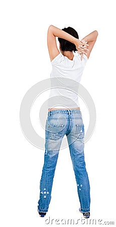 Back view of standing young beautiful brunette woman in jeans. Stock Photo
