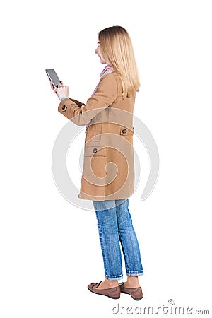 Back view of standing young beautiful girl with tablet computer Stock Photo