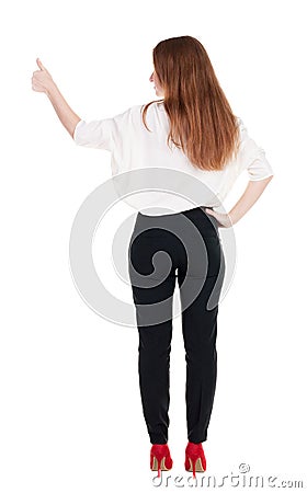 Back view of standing young redhead business woman showing thumb Stock Photo