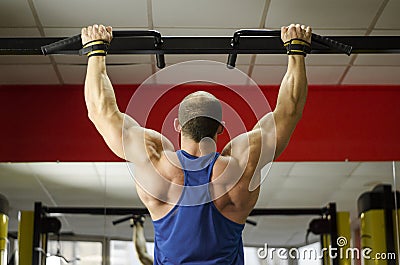 Back view of strong male athlete with perfect muscles training, doing exercises Stock Photo