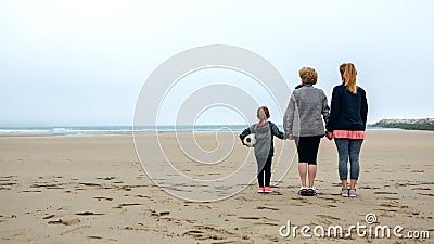Three generations female watching the sea Stock Photo