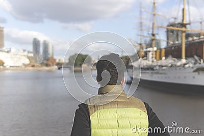 Back view of a tourist posing in front of a boat in Puerto Madero Stock Photo