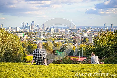 Tourists looking over London city skyline from Parliament Hill in Hampstead Heath Editorial Stock Photo