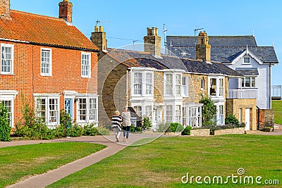Back view of two female tourists walking in the popular seaside town Southwold of the UK Editorial Stock Photo