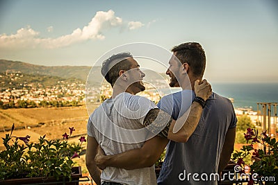 Back view of two gays embracing Stock Photo