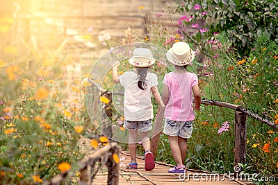 Back view of two little girls holding hand and walking together Stock Photo