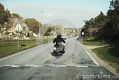 Back view of two motorcyclists on mountain road Stock Photo