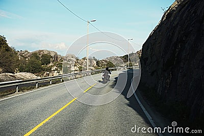 Back view of two motorcyclists on mountain road Stock Photo