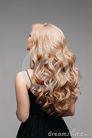 Stunning woman with perfect wavy blonde hair. Stock Photo