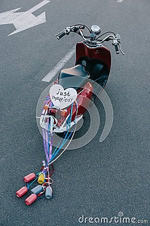 back view of vintage moped with colorful cans ribbons and just married Stock Photo