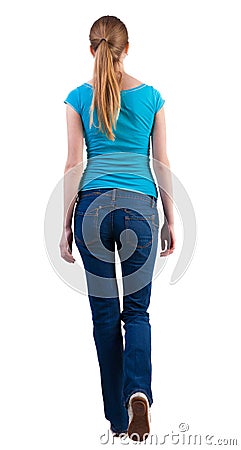 Back view of walking woman in jeans and shirt. Stock Photo