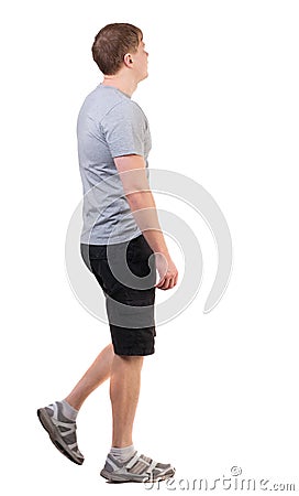 Back view of walking handsome man in shorts and sneakers. Stock Photo