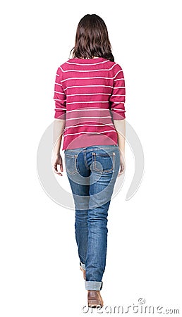 Back view of walking woman in striped sweater. Stock Photo