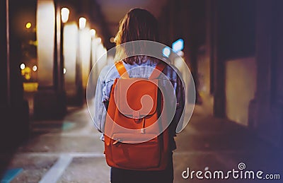 Back view woman with backpack on background bokeh light in night atmospheric city, blogger hipster planing holiday travel, mockup Stock Photo